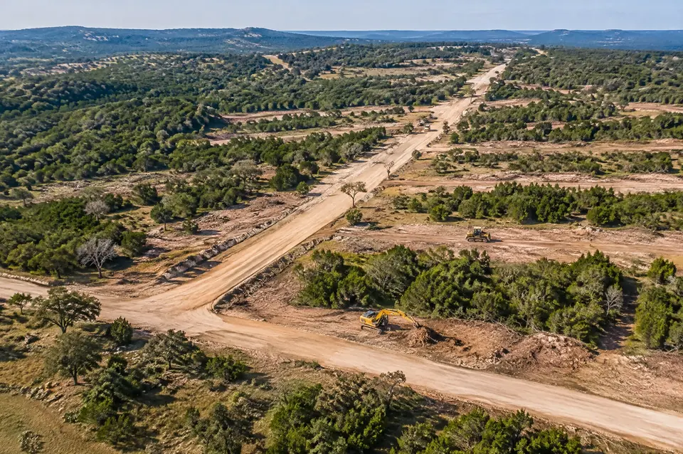 Lot line clearing: aerial view of cleared street corridors and lot lines cut through cedar