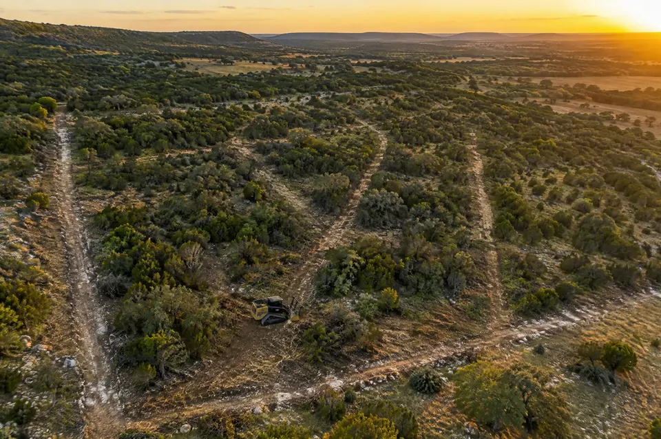 Land clearing for real estate: aerial view of a commercial tract with cleared boundary and survey lines