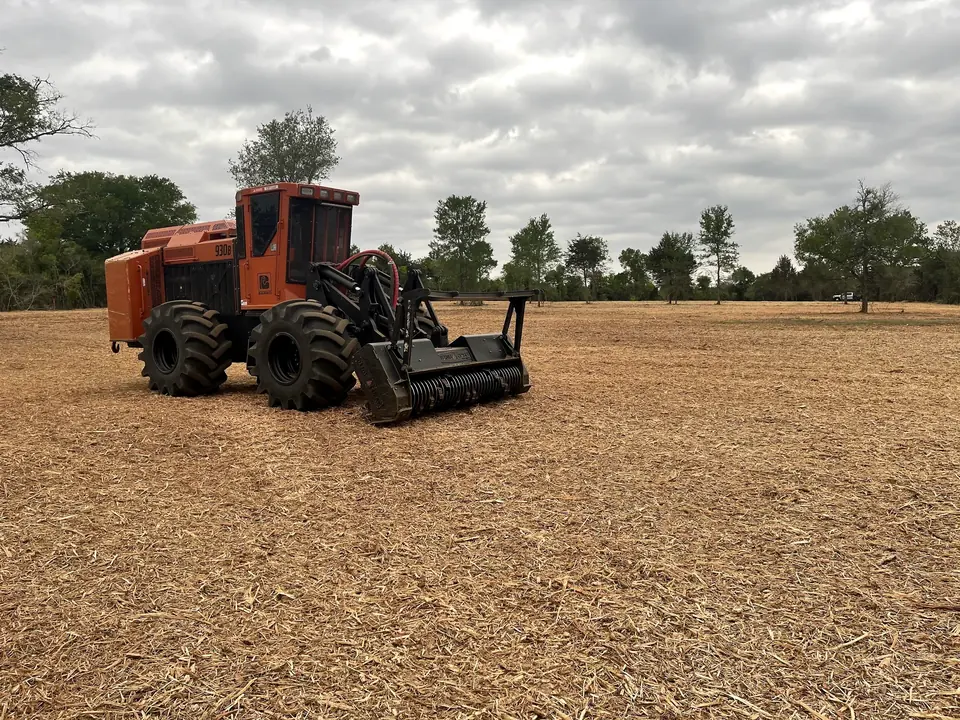 Articulated mulcher working across a large cleared field