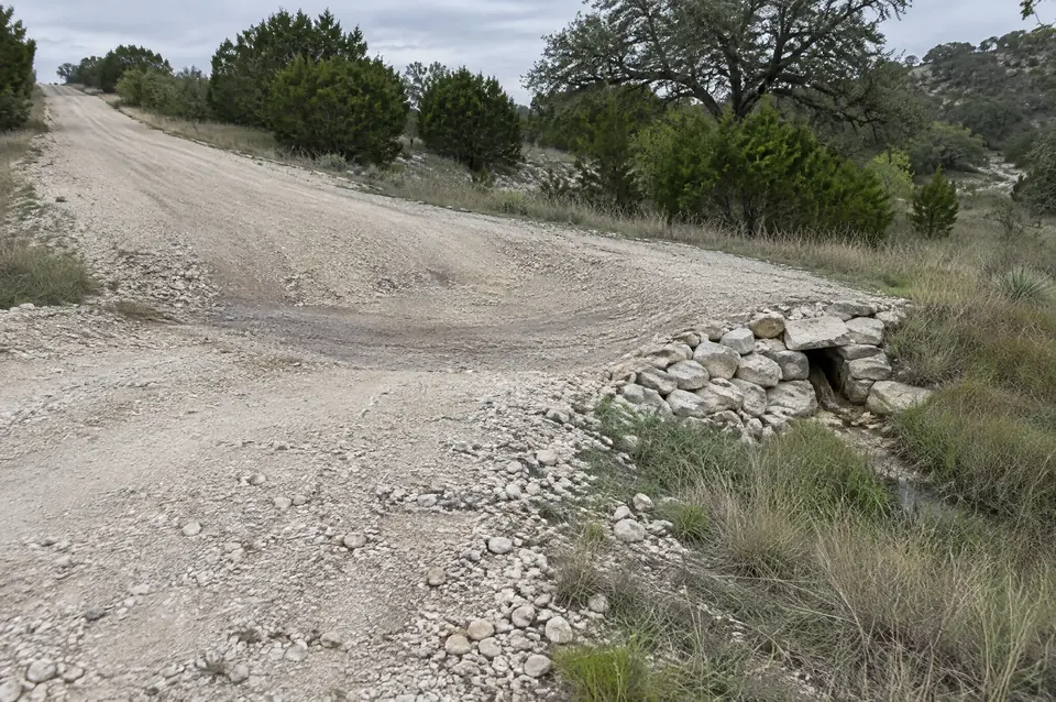 Ranch road construction: broad-based dip turning runoff off a crushed limestone ranch road