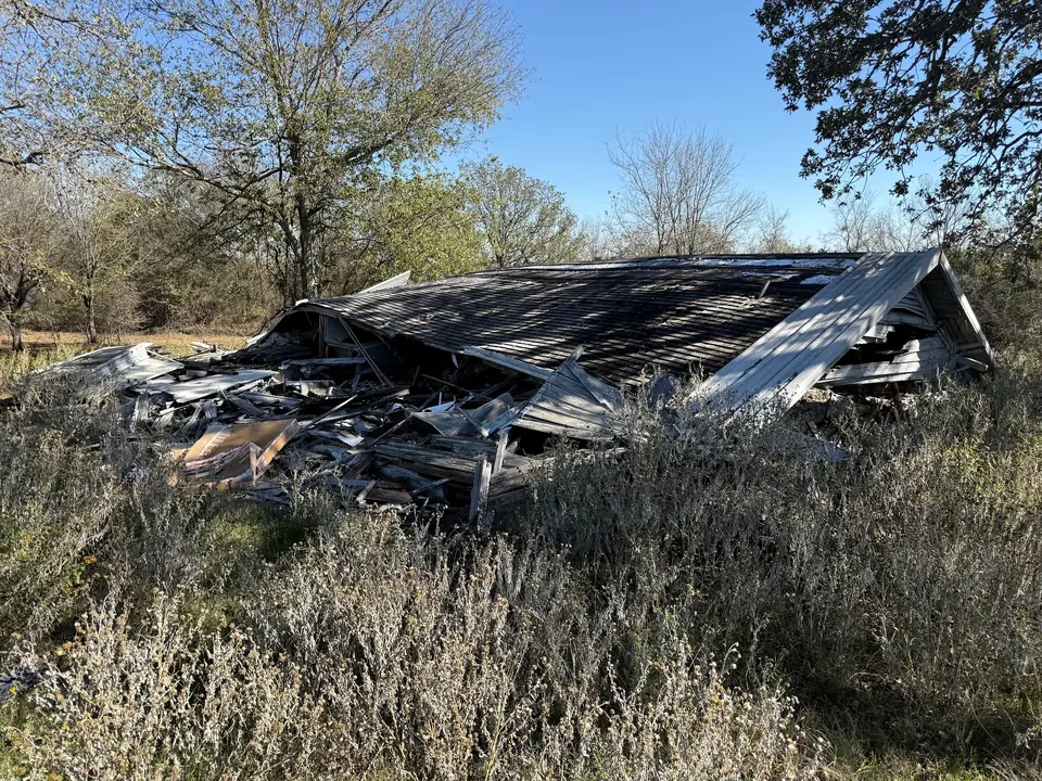Collapsed barn at Brazos Point before demolition and cleanup