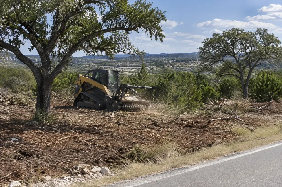 Commercial land clearing Central Texas: commercial tract cleared along the road frontage with a few oaks kept