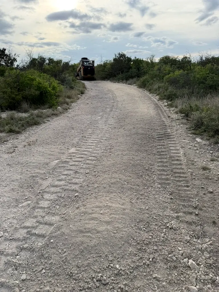 Crushed rock road with track marks after on-site rock crushing