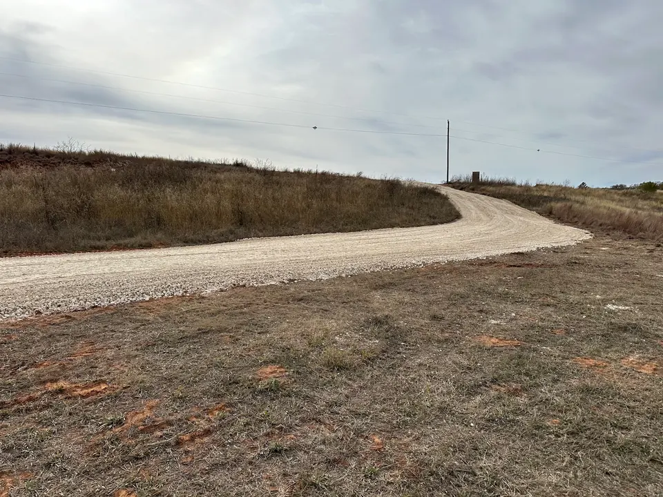 Curving access road across open ground