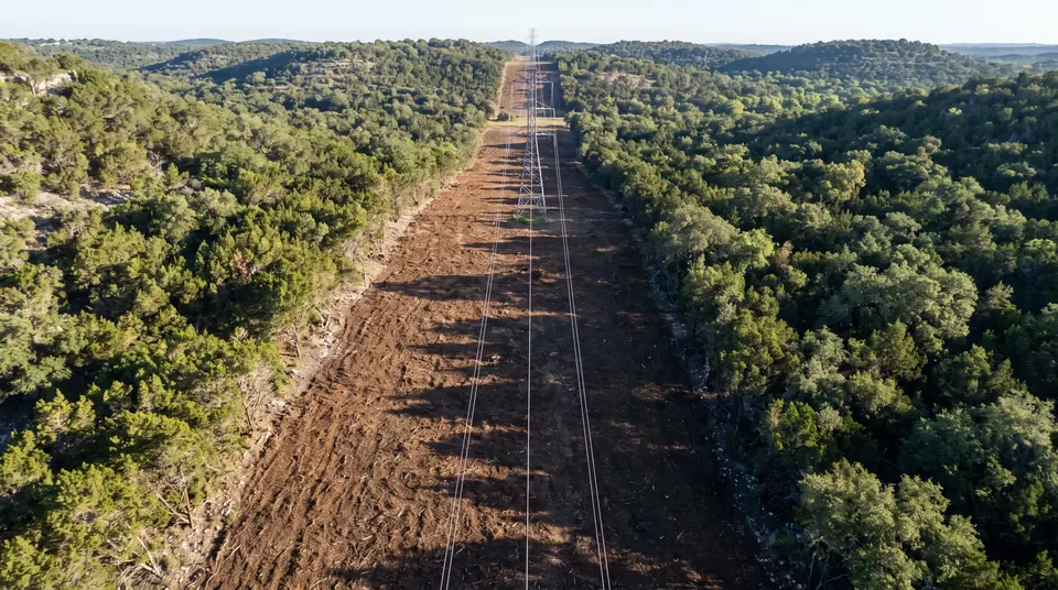 Electrical right-of-way safety manual: aerial view of a cleared power line right-of-way through Hill Country woodland