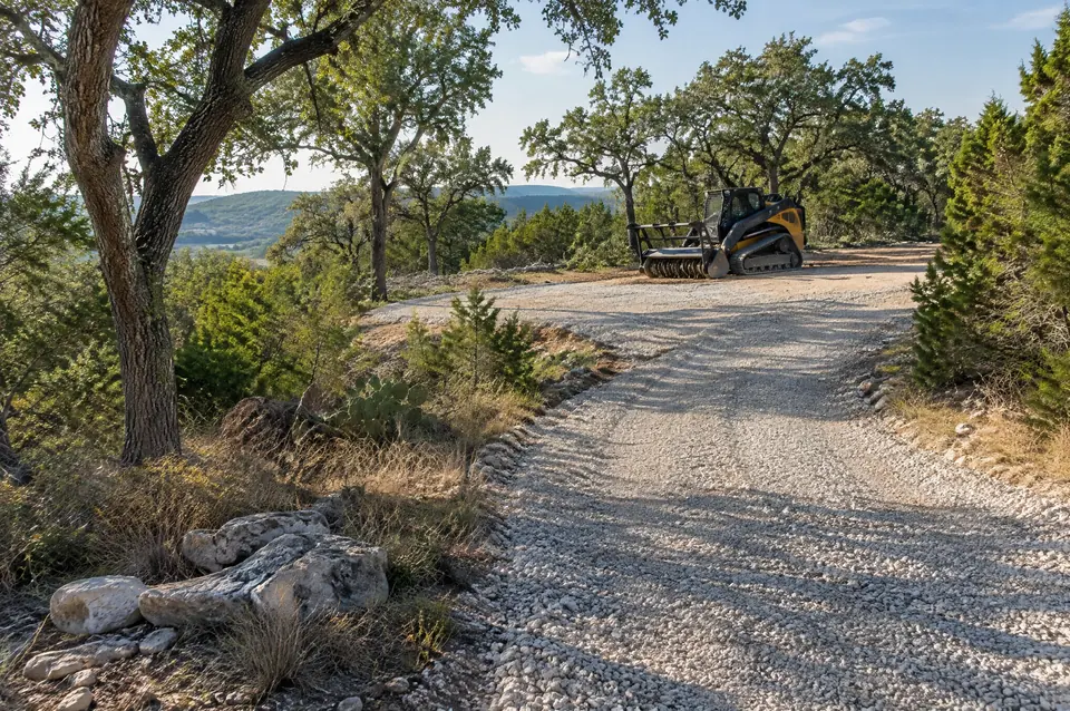 Rock milling: finished crushed rock driveway leading to a homesite among oaks