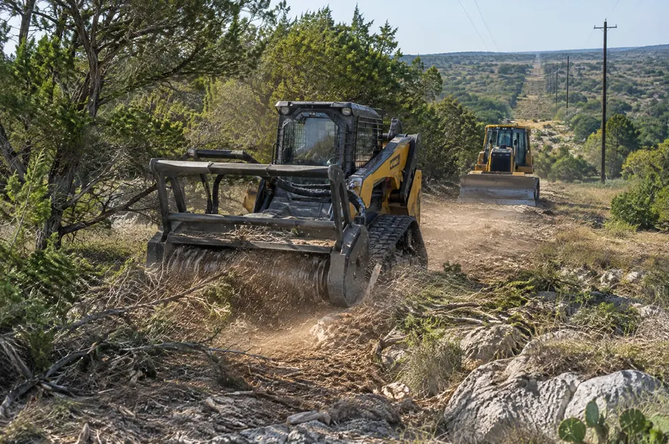 Utility land clearing Texas: forestry mulcher clearing a utility corridor, dozer behind it