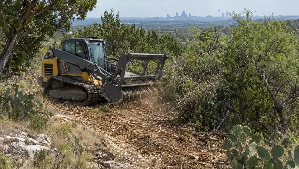 Forestry mulching in San Antonio, TX: forestry mulcher in cedar, mesquite and prickly pear on San Antonio's north edge, skyline beyond