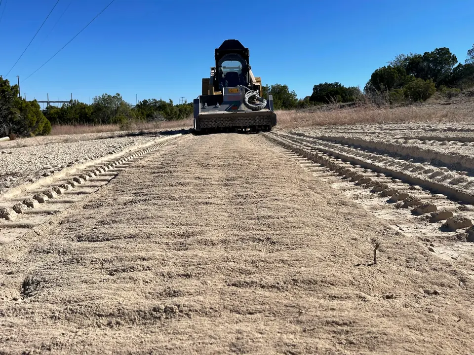 Grading a road with a track loader