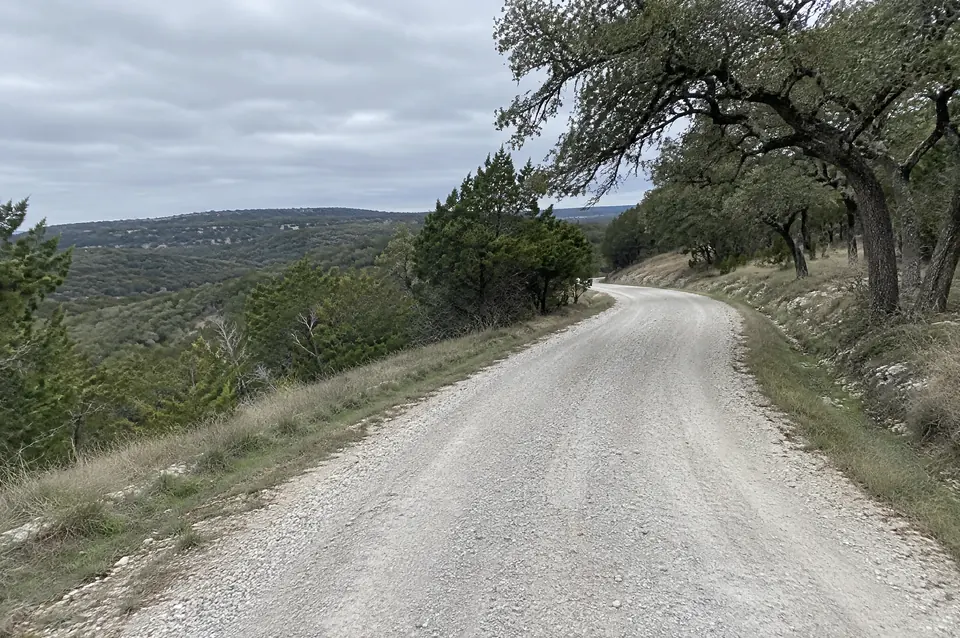 How to build a ranch road: New crushed limestone ranch road with a crowned surface along a cedar ridge