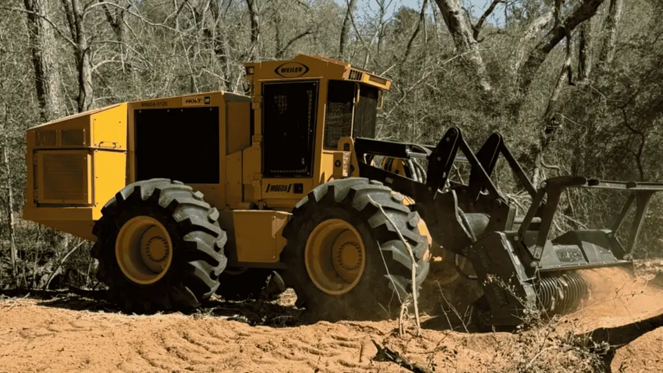 Land clearing in Central Texas: large yellow articulated forestry mulcher clearing brush on a 9 Arrow job
