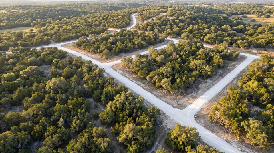 Land clearing for developers in Central Texas: aerial view of Hill Country land with cleared street corridors and lot lines for a subdivision