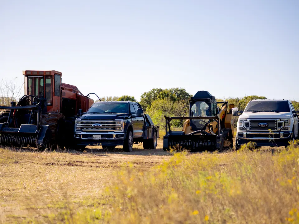 Land clearing in east Texas: 9 Arrow forestry mulchers and crew trucks lined up on a job site