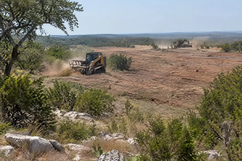 Subdivision clearing Bexar County: large flat brush tract south of San Antonio being cleared by mulchers