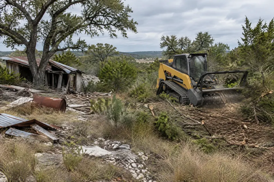 Commercial property clearing: old shed ruins and debris on brushy commercial land, track mulcher clearing