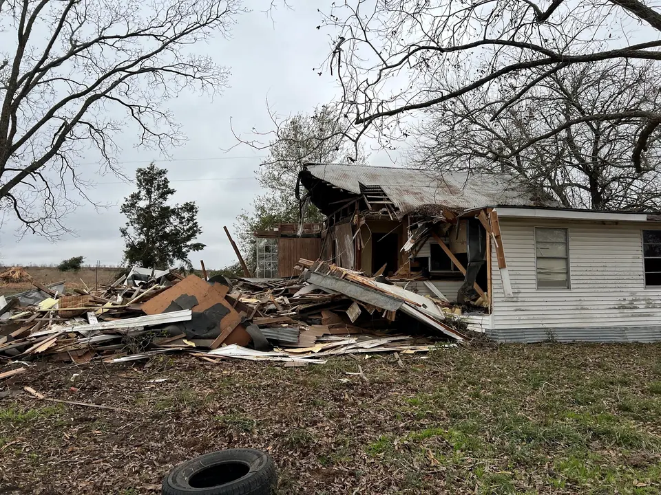Partly collapsed house and debris at Sandy Hill before demolition