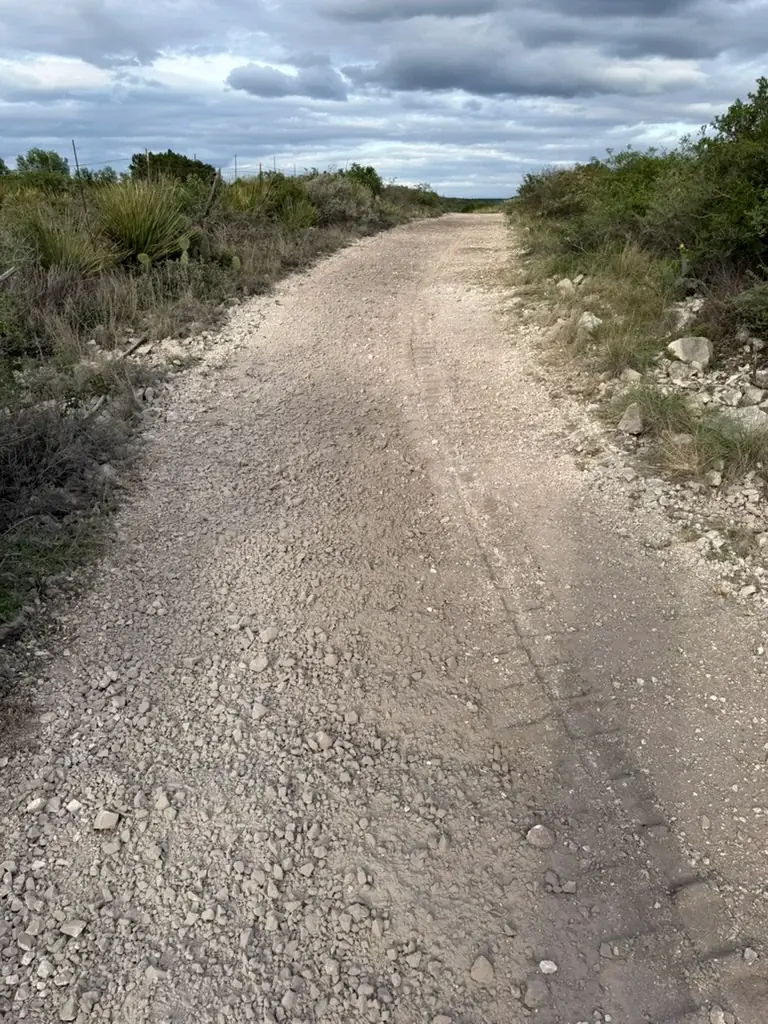 Ranch road after rock crushing, with a smooth crushed limestone surface