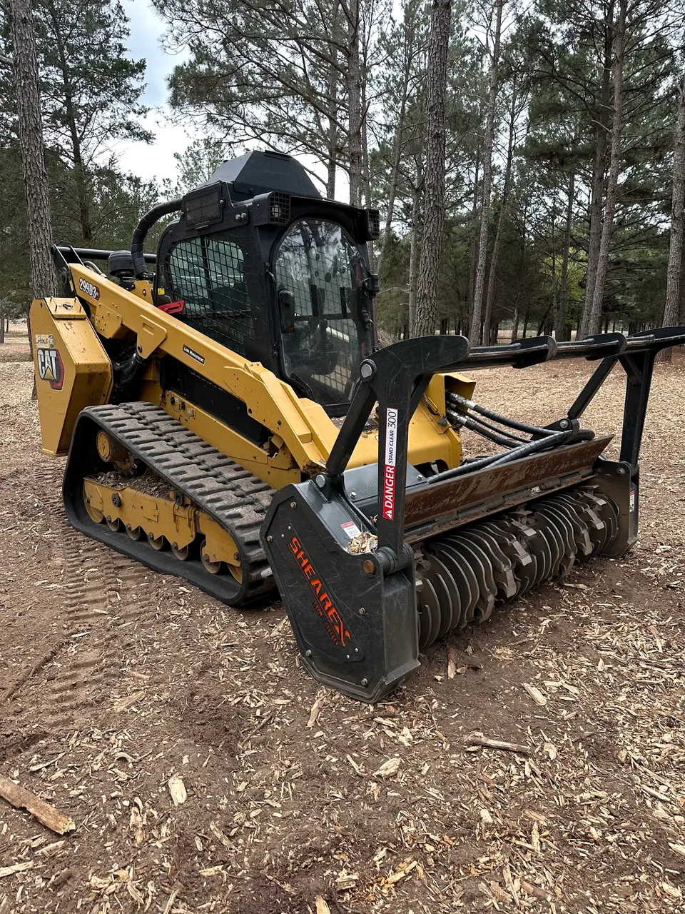 Track loader with a mulching head on fresh mulch