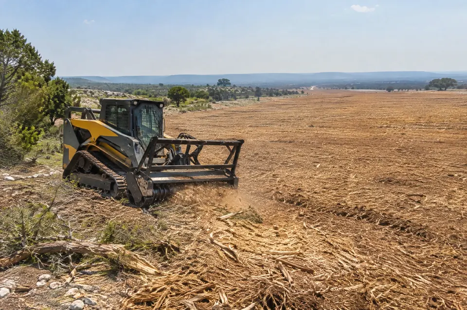 Solar farm land clearing Texas: track mulcher on large acreage cleared flat for a solar farm