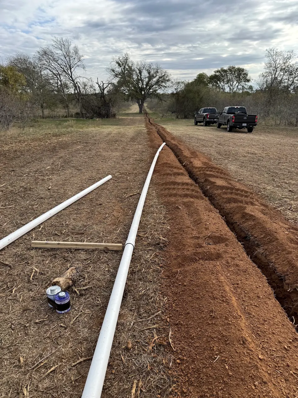 Waterline pipe laid beside an open trench
